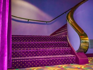 Purple, carpeted interior staircase of Capitol theater