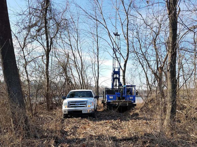 Truck and Central Mine Equipment drill rig in wooded area