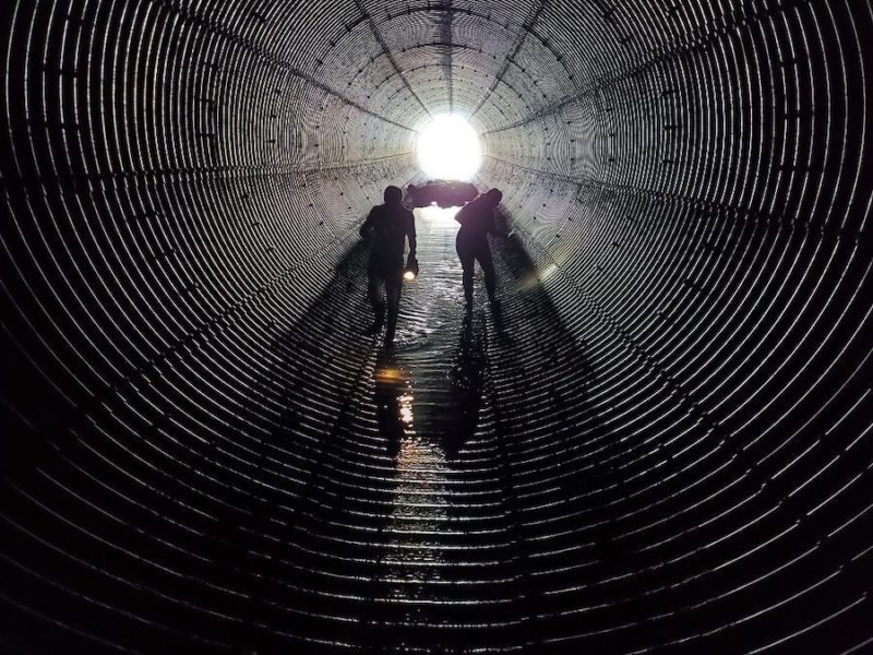 Two workers inspecting outlet