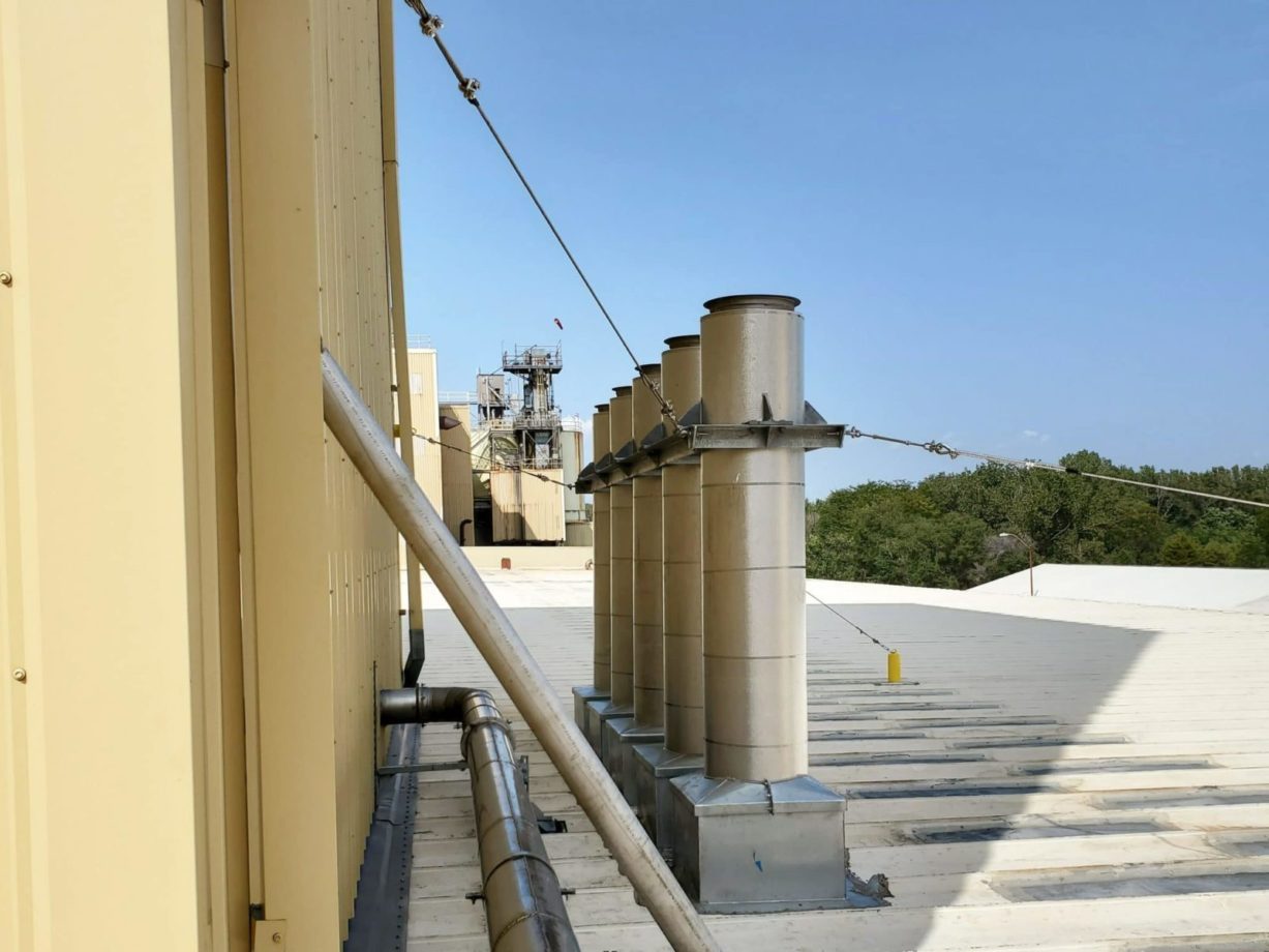 Relocated exhaust stacks on roof on an industrial processing plant