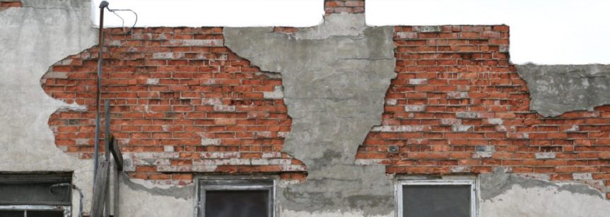 Historic brick exterior with stucco damage