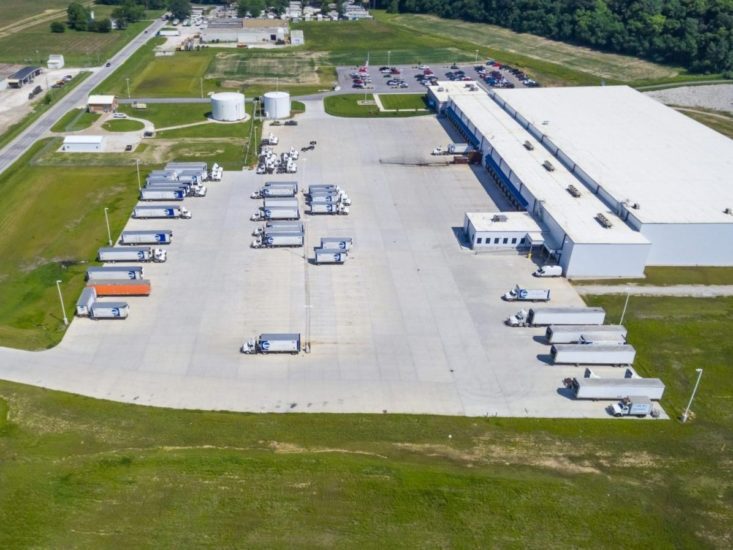 Aerial view of warehouse loading dock, parking lot, and some semi trucks