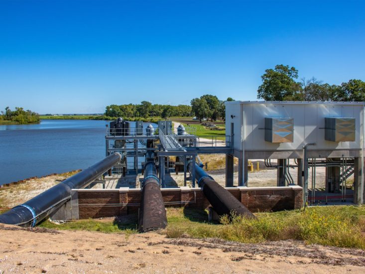 A pump station with three discharge pipes and an elevated pump house