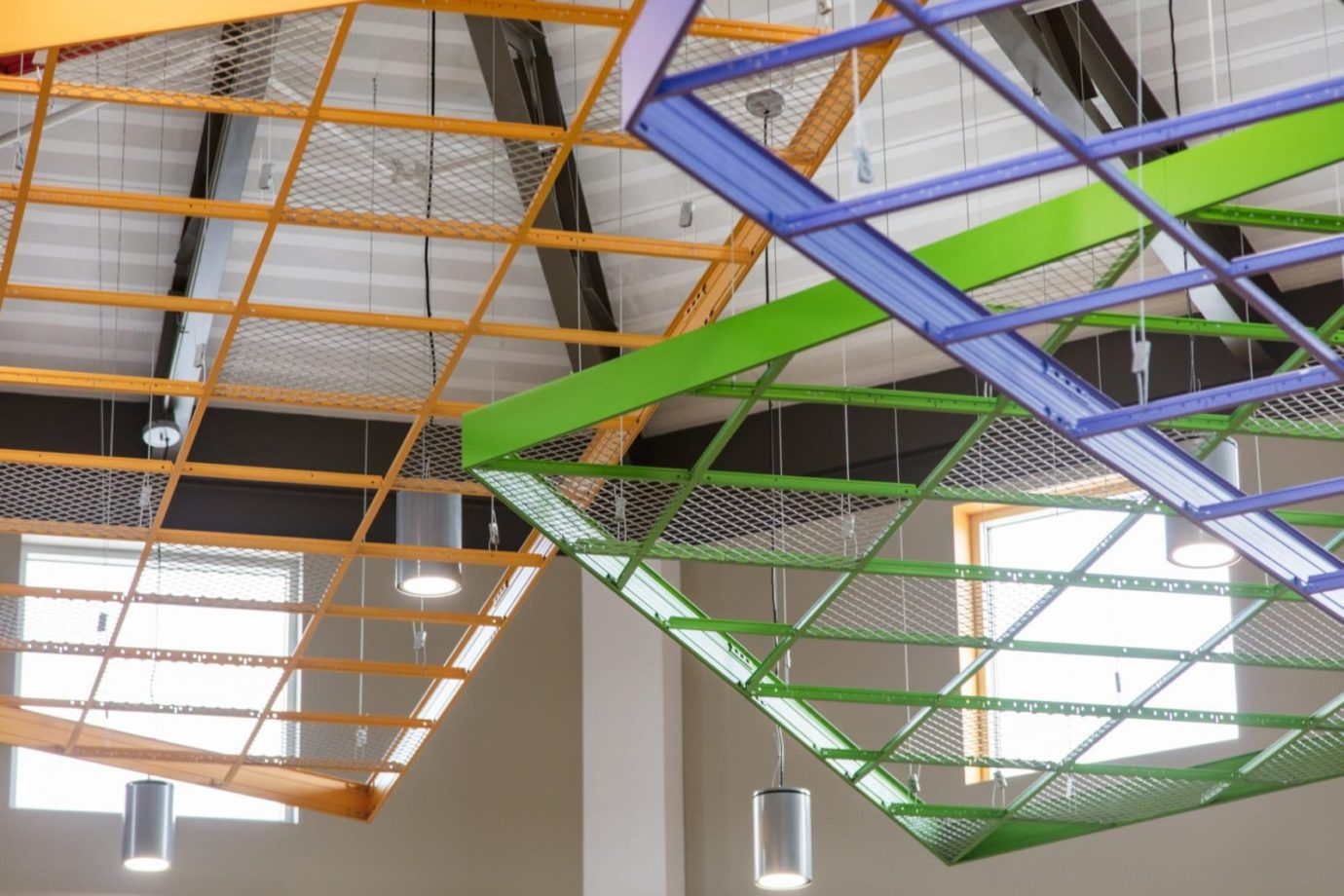 Purple, Green, and Yellow geometric structural elements suspended from the ceiling