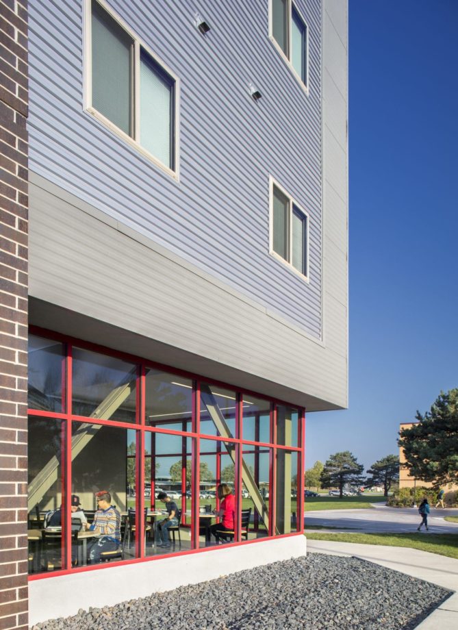 Exterior view of dorm building looking into the student lounge space