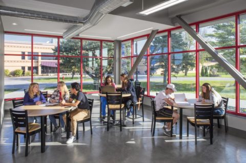 Students working at tables in the lounge