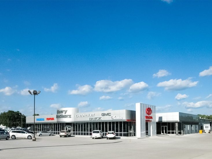 Cars in front of a car dealership