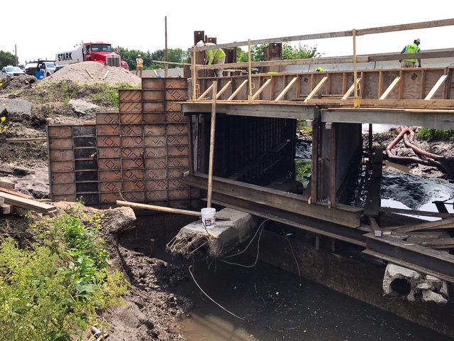 Workers constructing a bridge