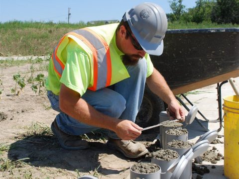 A man filling concrete cylinders