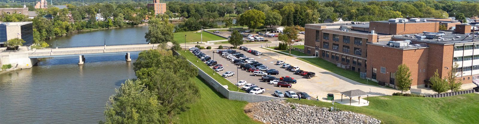 A floodwall and levee protecting a high school