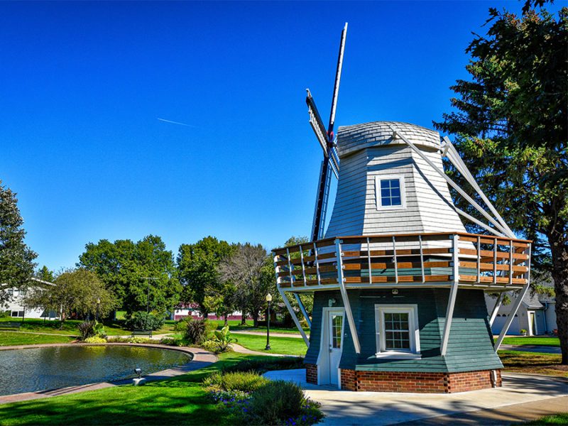 A windmill next to a pond