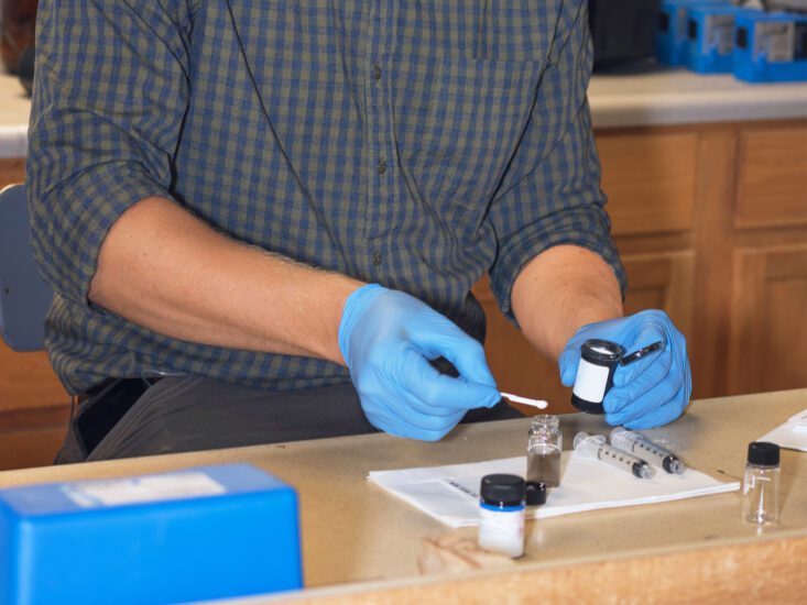 A man performing a water test in a lab