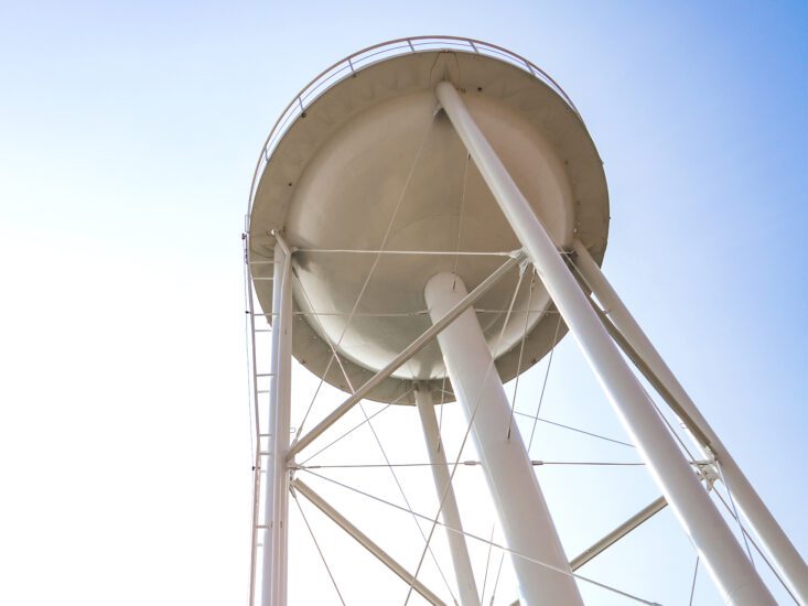 The view from the ground looking up at a water tower
