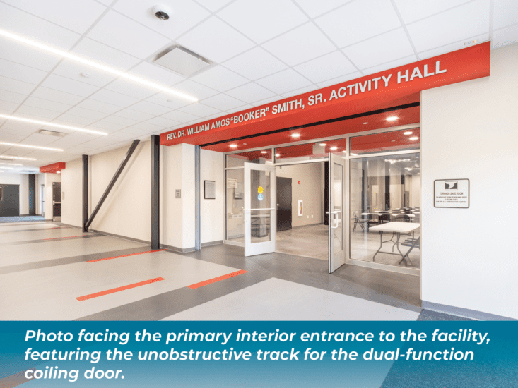 Photo facing the primary interior entrance to the facility, featuring the unobstructive track for the dual-function coiling door.